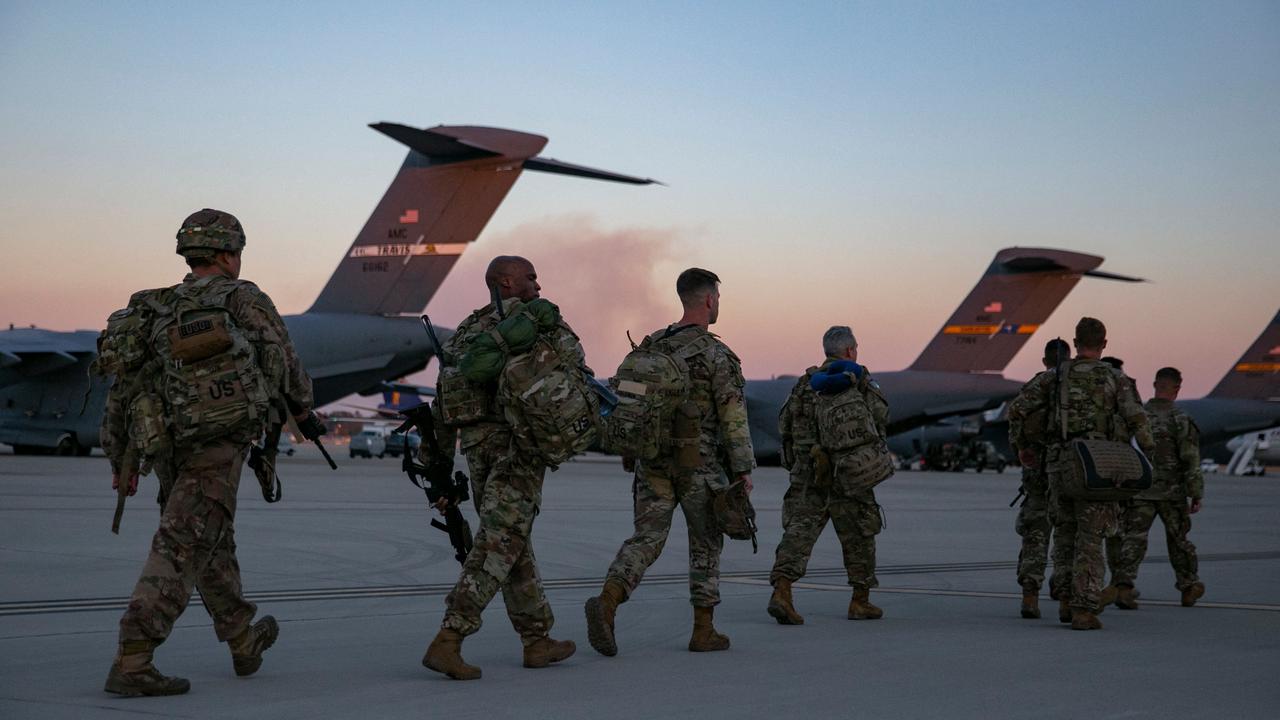 US soldiers walk to board a plane in Fort Bragg, North Carolina. With recruitment rates falling, attention is turning to the rise of woke politics. Picture: AFP