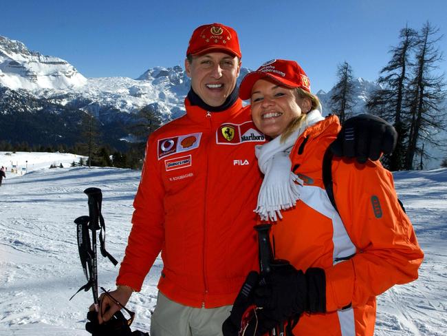 (FILES) Formula one World champion Ferrrari driver Michael Schumacher (L) poses in Madonna di Campiglio with his wife Corinna  16 January 2003. Two men accused of trying to blackmail relatives of Formula One legend Michael Schumacher had access to private family photos, German prosecutors said on July 3, 2024. Data records combed by investigators included "photo files relating to the Schumacher family's private life", the prosecutors in the western city of Wuppertal said in a statement. German authorities announced in June 2024 they had arrested a father and son on suspicion of trying to blackmail the Schumacher family. (Photo by Ercole COLOMBO / POOL / AFP)