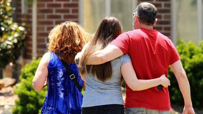 Mourners comfort each other after the death of Celeste Manno. Picture: Mark Stewart