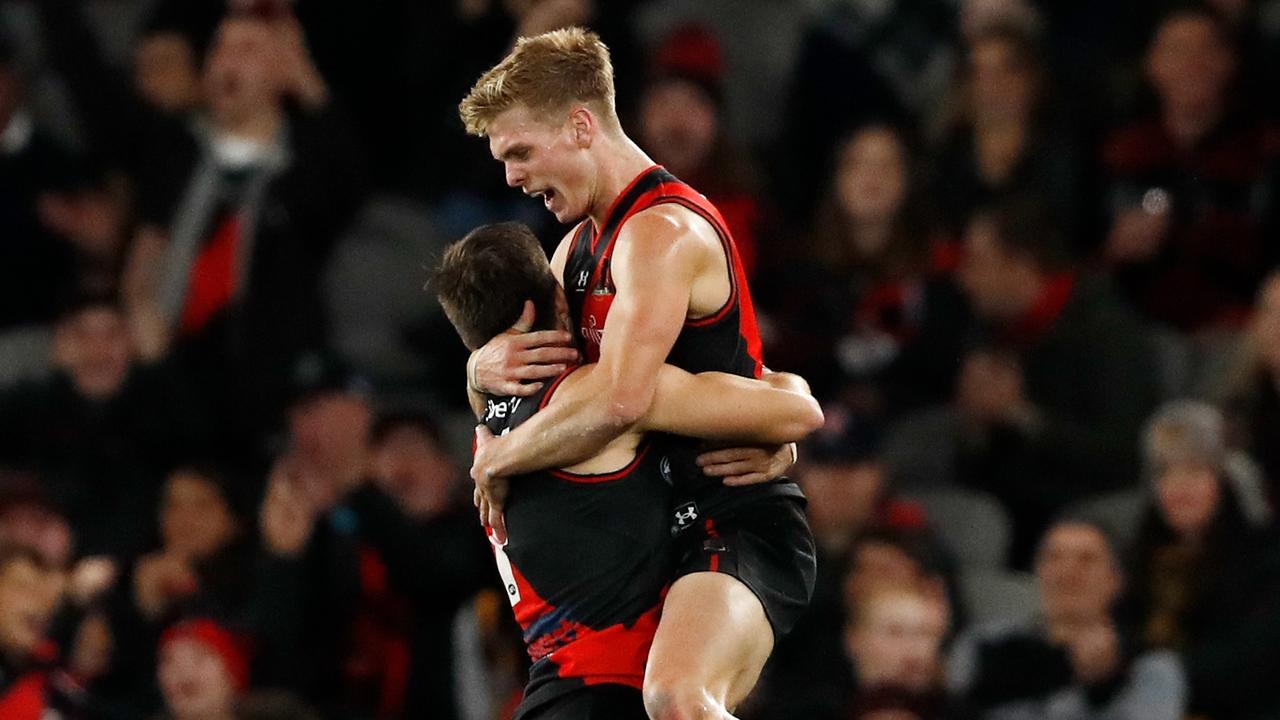 Ben Hobbs of the Bombers celebrates a goal with Zach Merrett. Picture: Dylan Burns