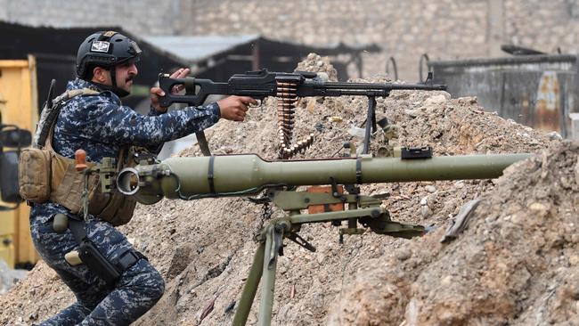 A new war: Iraqi Federal Police do battle with Islamic State fighters in Mosul. Picture: AP