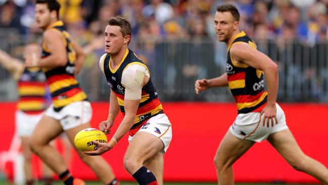 Matt Crouch of the Crows looks to handpass in the match against West Coast Eagles at Optus Stadium in Perth. Picture: AAP Image/Richard Wainwright