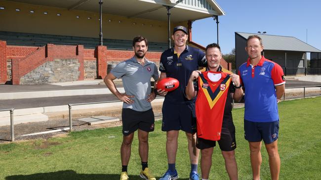 New SANFL state coach Darren Reeves (holding the state jumper), with his state assistant coaches, from left, Sam Mayes (North Adelaide), Sam Jacobs (Woodville-West Torrens) and Paul Thomas (Central District) at Tanunda Recreation Park. Picture: David Mariuz/SANFL