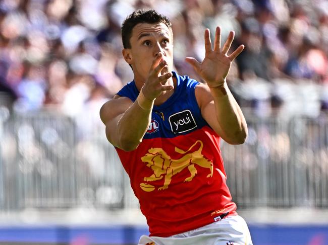 PERTH, AUSTRALIA - MARCH 17: Hugh McCluggage of the Lions sets for a mark during the 2024 AFL Round 01 match between the Fremantle Dockers and the Brisbane Lions at Optus Stadium on March 17, 2024 in Perth, Australia. (Photo by Daniel Carson/AFL Photos via Getty Images)