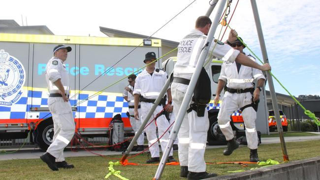 Police Rescue set-up their equipment ahead of lowering medical personnel in a harness over a short height to familiarise them with cliff rescue techniques at a joint operational exercise with NSW Ambulance and the Westpac Rescue Helicopter crews at Lismore on June 1, 2021. Photo: Alison Paterson