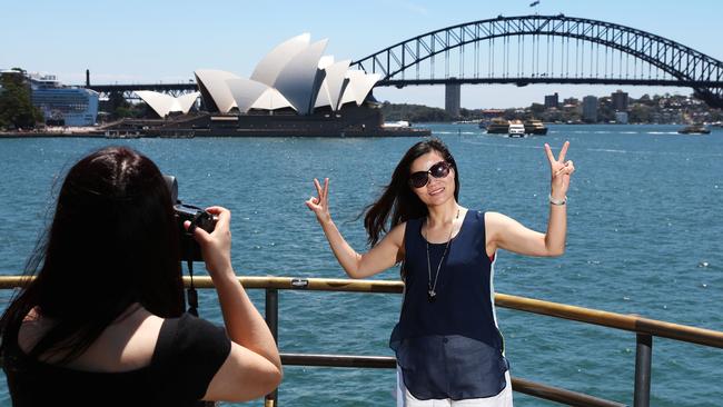 Chinese tourists Li Dong and Caihui Li take in the sights at Mrs Macquarie's Chair, Sydney in 2017. Picture: Brett Costello