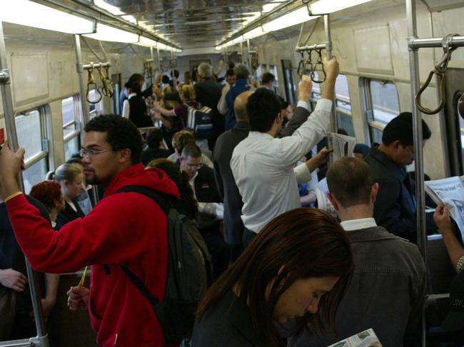 21/04/2004. Train commuters are packed into a crowded M>train. Passengers. Digital Image