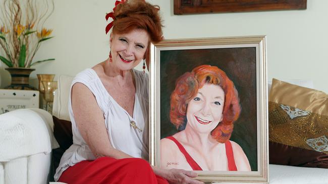 Photo of Kate Peters with the portrait Jock McIlwain painted of her. He was her great friend and the sponsor of the Gold Coast Area Theatre awards and received the awards' top honour in December for his long history of financial support of the arts and young artists on the gold coast. Jock died recently. Picture: Richard Gosling