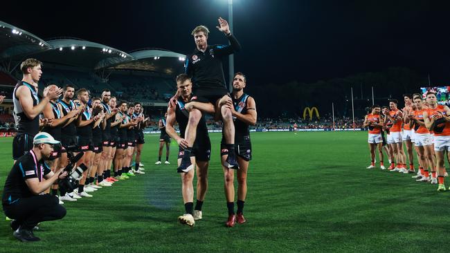 Both teams pay their respects to retiring Port skipper Tom Jonas. (Photo by James Elsby/AFL Photos via Getty Images)