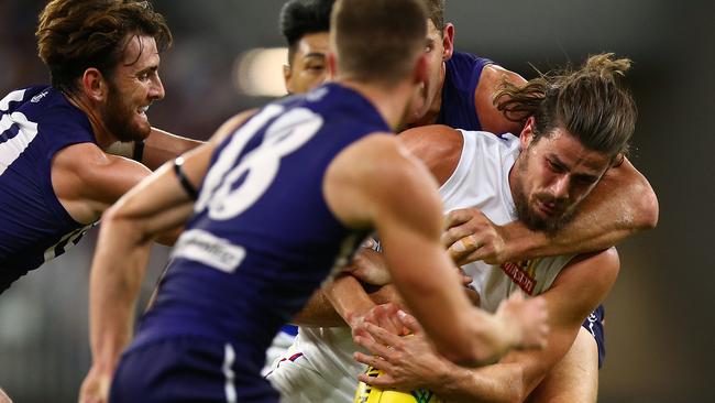 Tom Boyd is gang-tackled on a dirty night for the Dogs.