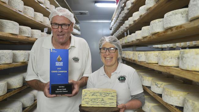 Berrys Creek Cheese owners Barry Charlton and Cheryl Hulls in their cheese storage room with their prize-winning Oak Blue Cheese. Picture: Dannika Bonser