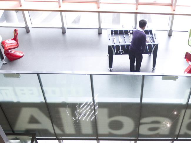 People walk through Alibaba.com Ltd.'s headquarters in Hangzhou, Zhejiang Province, China, on Friday, Feb. 24, 2012. Alibaba Group Holding Ltd. will seek about three to five more senior banks for a $3 billion loan, according to a person familiar with the matter. Photographer: Nelson Ching/Bloomberg