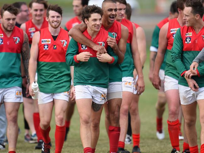 MPNFL Division 1: Mt Eliza v Frankston Pines.Jubilant Frankston Pines players including #21 Daniel John giving team mate #4 Tom McDermott a congratulatory hug, leave the ground after defeating Mount Eliza. Picture: Jason SammonSaturday 14 April 2018