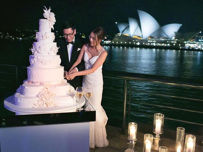 Natasha Lau and Andreas Wong cutting their seven-tier wedding cake.