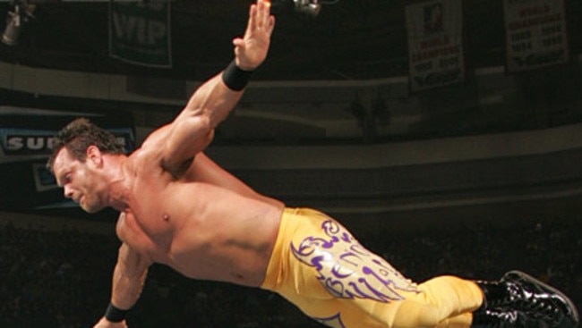 WWE wrestler Chris Benoit flies off the top rope in a choreographed move.