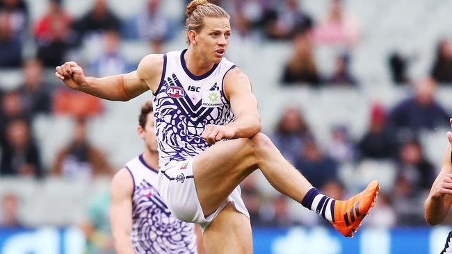 Nat Fyfe gets a kick away for Fremantle.