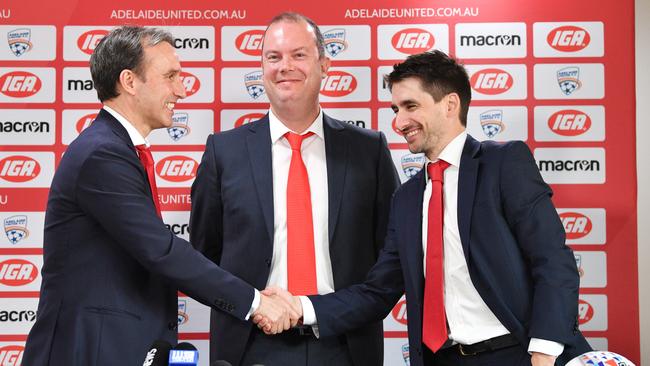 Aurelio Vidmar, left, with Adelaide chairman Piet van der Pol and CEO Nathan Kosmina