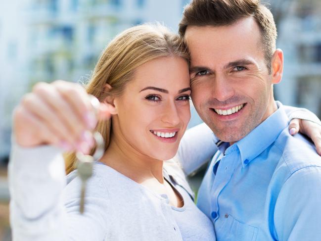 First home buyers purchasing a new property. Holding keys at the front of the property. Picture: iStock.