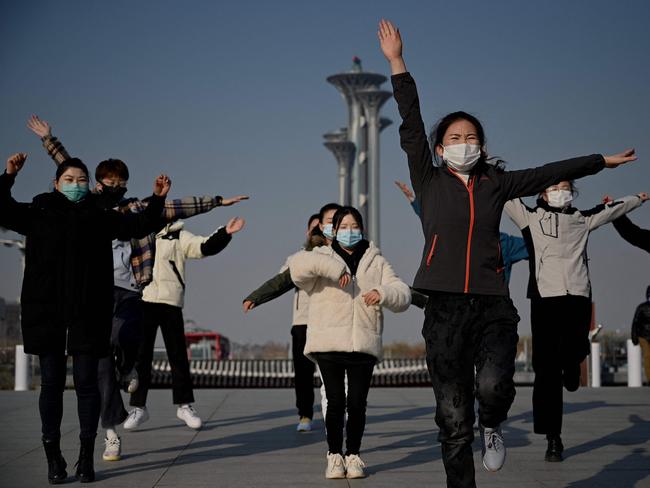 People dance at the Beijing Olympic Park in Beijing, host to the 2022 Winter Olympic Games in one month's time. Picture: Noel Celis / AFP