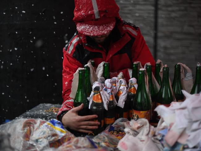 A volunteer demonstrates the preparation of Molotov cocktails at a brewery in the western Ukraine city of Lviv. Picture: AFP