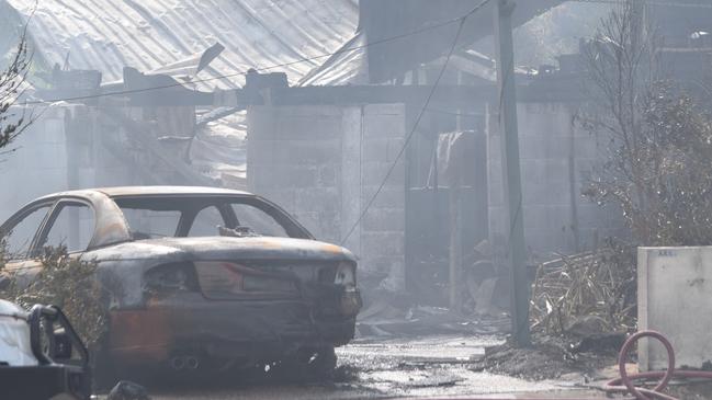 Smoke blankets the scene of a devastating house fire that left two people fighting for life early on Boxing Day. Photo: Daniel Shirkie.