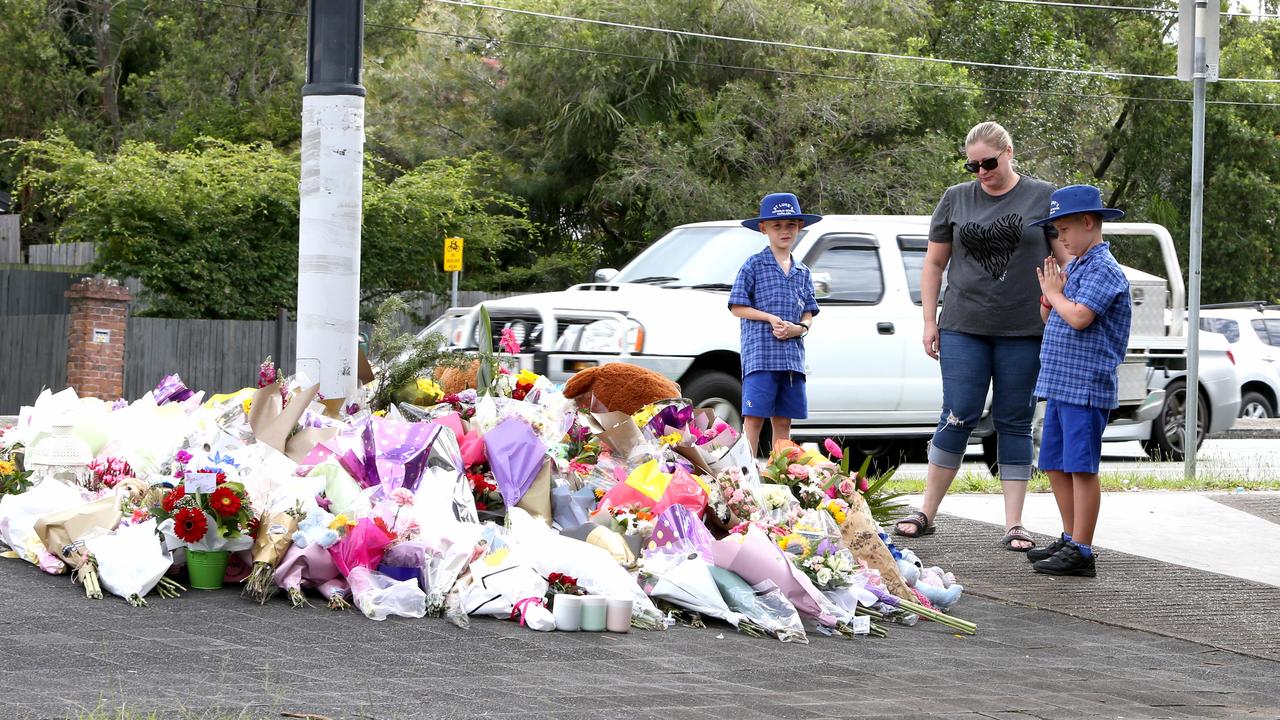 Mourners at the scene of the fatal crash. Picture: Steve Pohlner