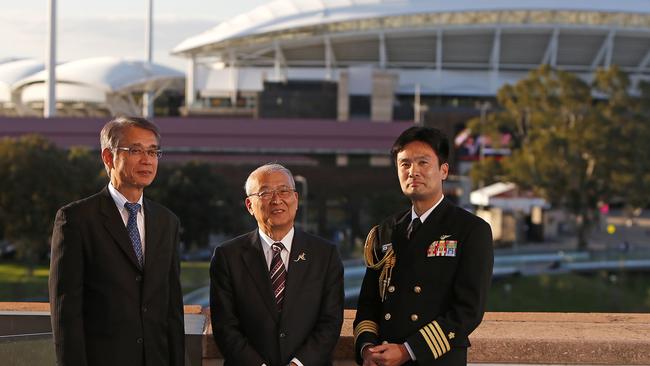 OFFICIALS: Hisakazu Mizutani of Mitsubishi, Admiral Takashi Saito and defence attache Hiroyuki Nakamura in front of Adelaide Oval. Picture: DYLAN COKER