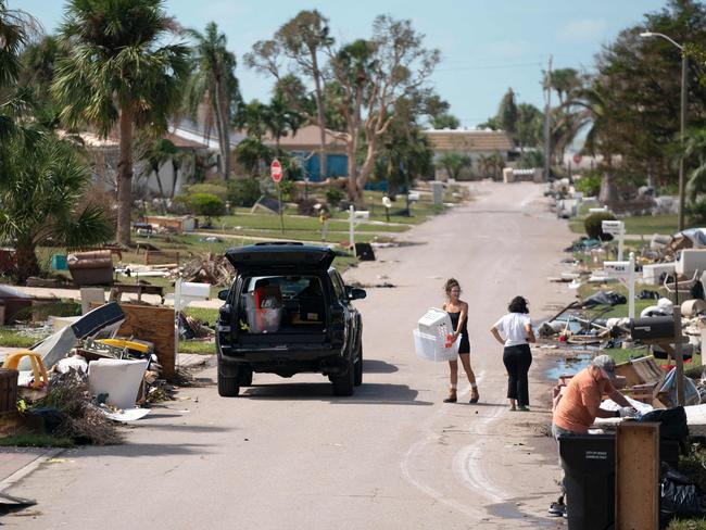 People clean up storm debris in the aftermath of Hurricane Milton. Picture: Getty Images via AFP