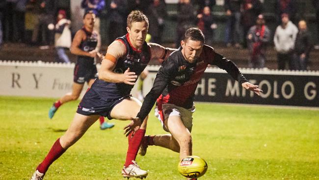 Redleg Simon Phillips chases Blood Jack Evans at Norwood Oval on Friday. Picture: Matt Loxton