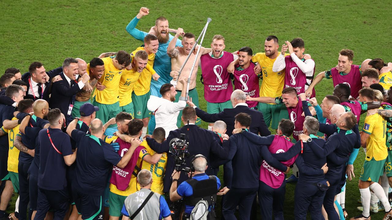 The Australian squad celebrates after the Denmark win.