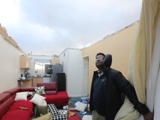 Surinder Kumar in his Glenelg North apartment, where the roof was blown off on Wednesday night. Picture: Russell Millard/AAP