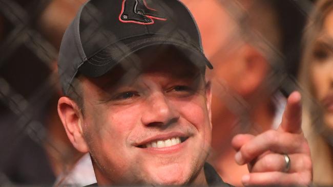 Hollywood actor Matt Damon gestures as he sits ringside at the event. Picture: Quinn Rooney/Getty Images