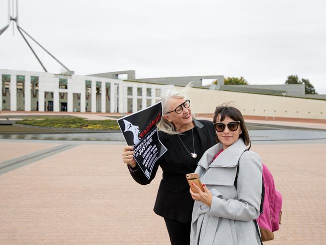 Janine Hendry, spokesperson for March 4 Justice, meets a supporter outside Parliament House in Canberra. Picture: Getty Images