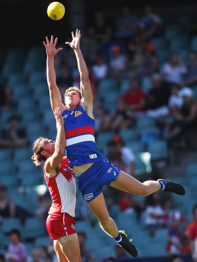 Aaron Naughton marks over Sydney’s Jordan Foote. Picture: Phil Hillyard