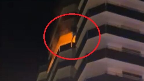 A man scaling the Equinox Resort building in Surfers Paradise to escape a fire. Picture: 9 News