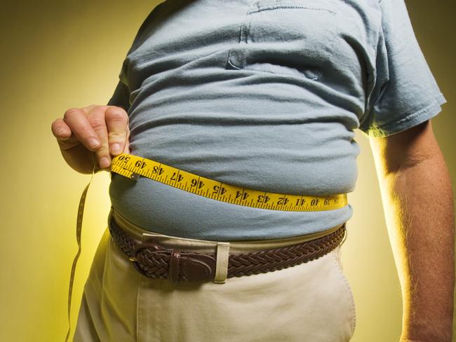 Man measuring his waist. Fat belly, overweight, tape measure, obesity.