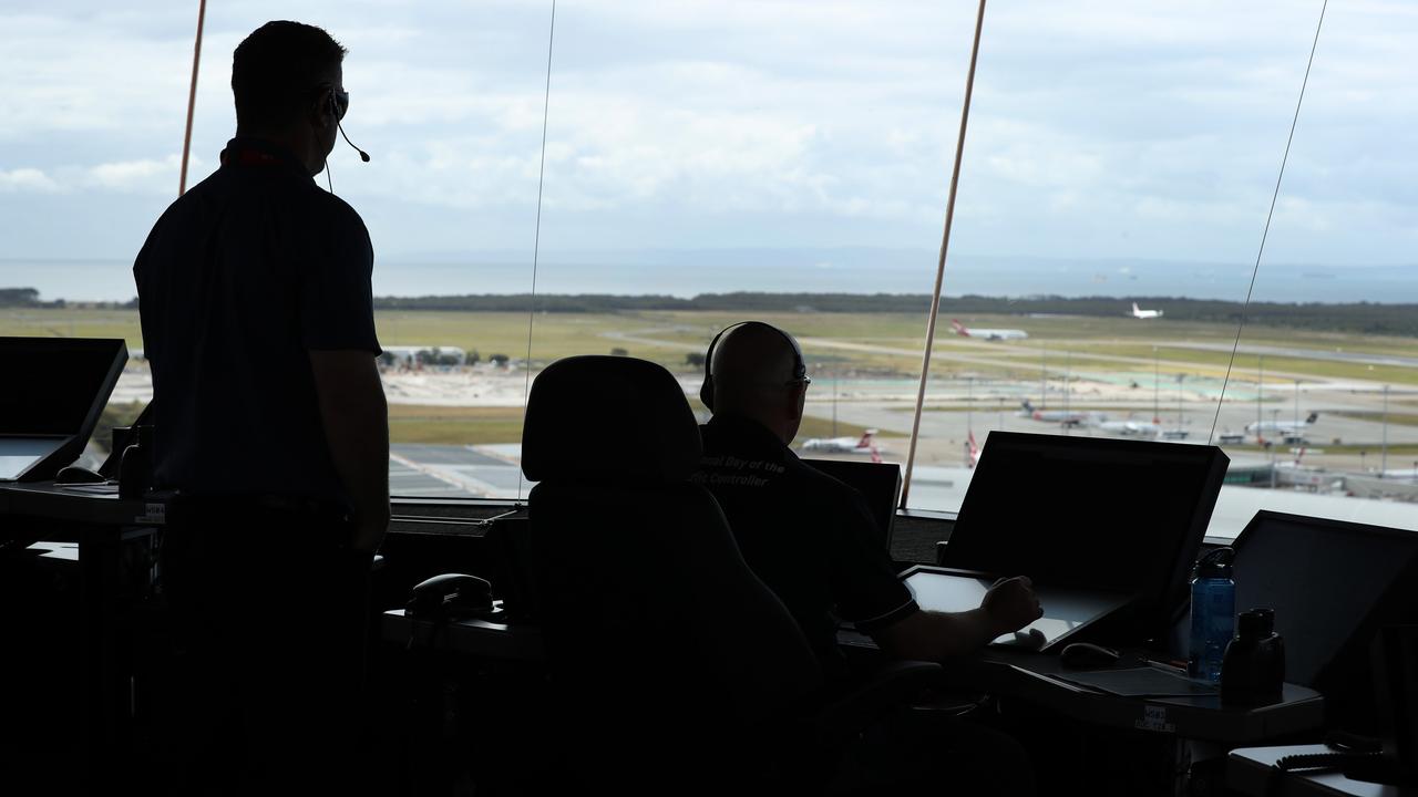 Air traffic controllers at work in the Brisbane Airport tower. Picture: Tara Croser.