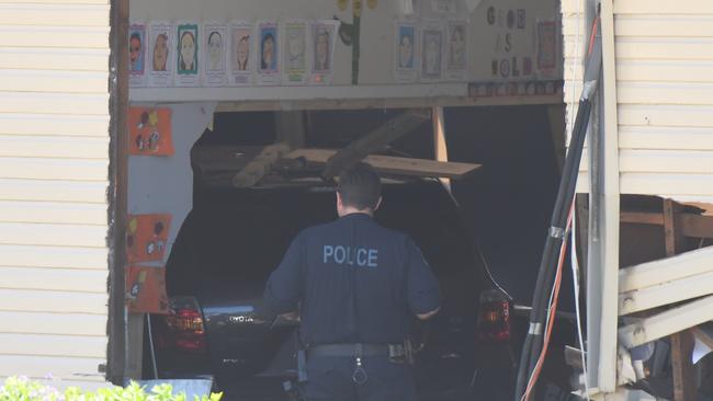 Police investigate the damaged building and 4WD. Picture: AAP