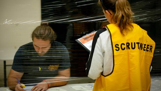 Scrutineers overseeing a vote count in the Territory. Picture Glenn Campbell