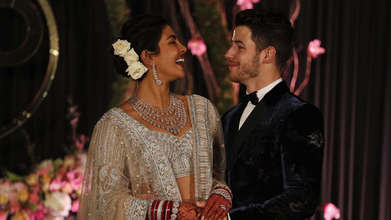 Bollywood actress Priyanka Chopra and musician Nick Jonas stand for photographs at their wedding reception in New Delhi, India. Picture: AP Photo/Altaf Qadri