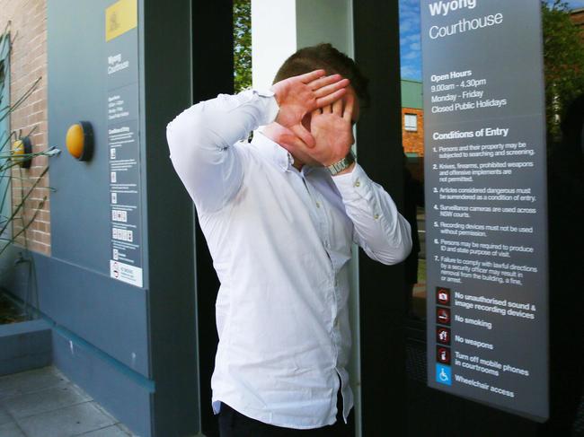 Huxley hiding his face as he arrived at an earlier appearance at Wyong Local Court. (AAP Image/Sue Graham)