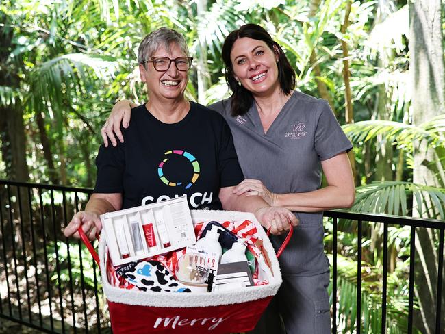 The team from the Aesthetic Lounge have kindly donated Christmas gift hampers, filled with chocolates, movie vouchers, eye masks, medical grade body and skincare products and massage vouchers, to eight deserving clients from COUCH Wellness Centre. COUCH client and cancer patient Jenni Mohamed receives a pamper pack as a special Christmas gift from The Aesthetic Lounge owner Katy Hirst. Picture: Brendan Radke