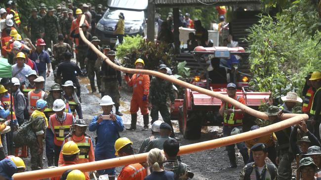 More pipes are brought in to drain the floodwaters. Picture: AP