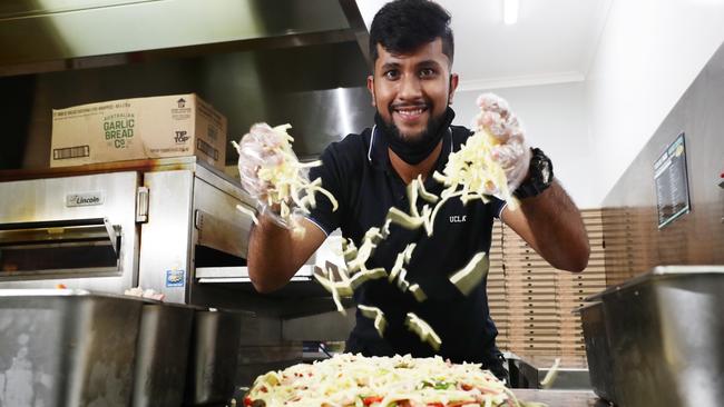 Manager of Pizza Del Mondo, Brian Bhandula creates a large supreme pizza with the lot for a hungry customer. Picture: Brendan Radke