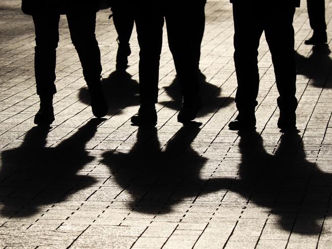 Crowd walking down on sidewalk, concept of strangers, crime, society, epidemic, population