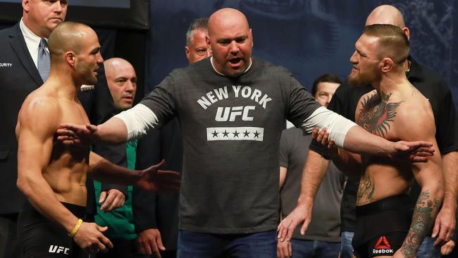 UFC president Dana White separates Conor McGregor (R) and Eddie Alvarez.
