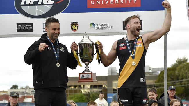 Heidelberg coach Vinny Dattoli and captain Keenan Posar hoist the premiership cup. Picture: Andrew Batsch