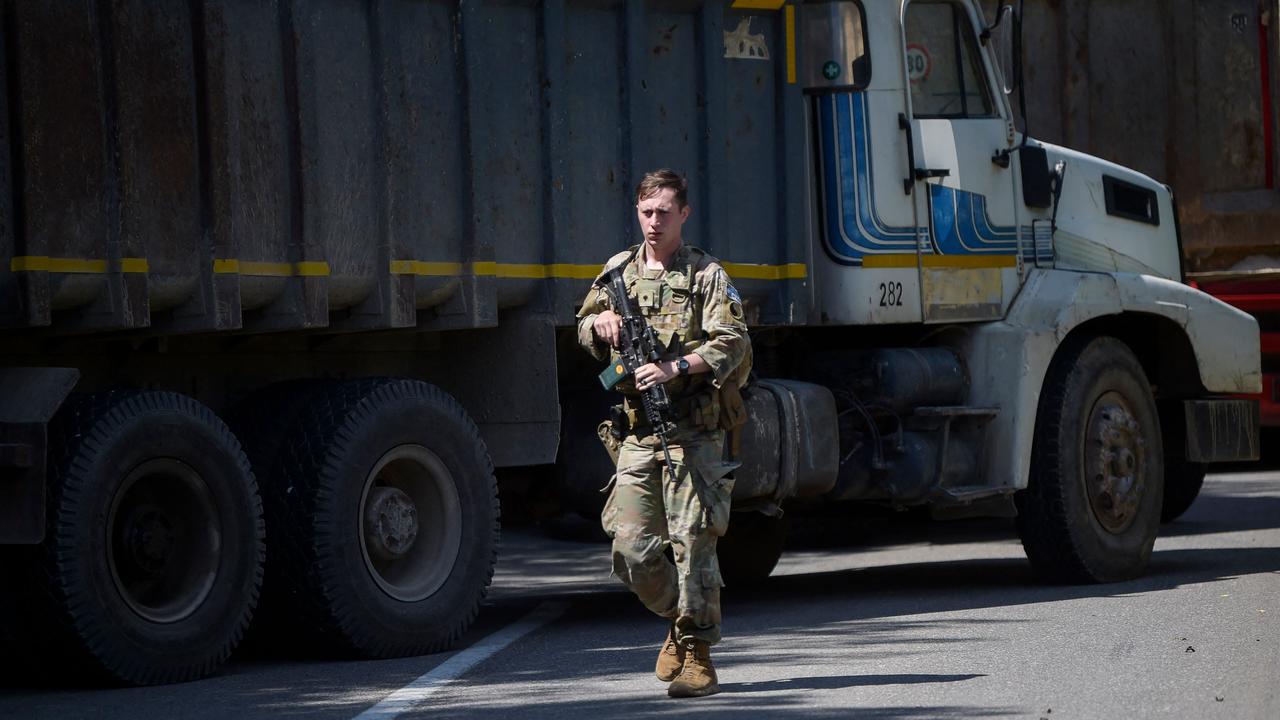 A US NATO soldier serving in Kosovo patrols next to a road barricade set up by ethnic Serbs near the town of Zubin Potok on August 1. Picture: Armend Nimani/AFP