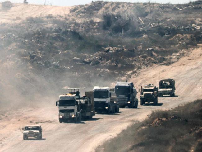 A convoy of Israeli civilian and military vehicles drives through the Gaza Strip along the Israel's southern border with the Palestinian territory on July 2, 2024, amid the ongoing conflict between Israel and the Palestinian militant group Hamas. (Photo by JACK GUEZ / AFP)