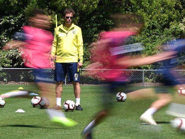 The Central Coast Mariners coach Mike Mulvey watches his playing squad during a training session at their training base in Gosford, Tuesday, October 23, 2018. Olympian Usain Bolt did not train with the team as negotiations regarding a player contract continue. (AAP Image/Dean Lewins) NO ARCHIVING